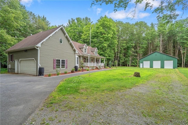 134 County Route 23a, Constantia, NY 13044 - view of front of home with a detached garage, covered porch, and a front lawn