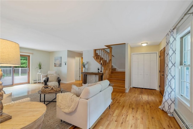 134 County Route 23a, Constantia, NY 13044 - living room with a baseboard radiator, stairs, light wood finished floors, and baseboard heating
