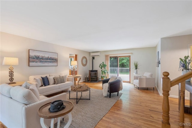 134 County Route 23a, Constantia, NY 13044 - living area with a wood stove, light wood-style flooring, and an AC wall unit