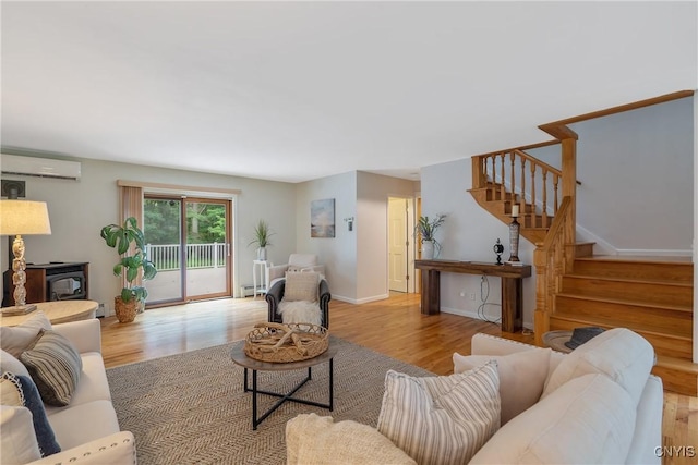 134 County Route 23a, Constantia, NY 13044 - living area with an AC wall unit, stairway, a wood stove, and wood finished floors
