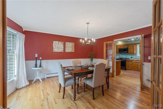 134 County Route 23a, Constantia, NY 13044 - dining room featuring light wood-style floors, plenty of natural light, a chandelier, ornamental molding, and baseboard heating