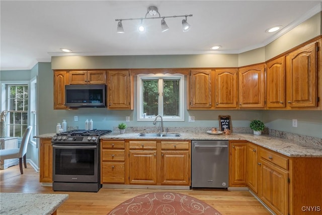 134 County Route 23a, Constantia, NY 13044 - kitchen with appliances with stainless steel finishes, brown cabinets, light stone counters, ornamental molding, and recessed lighting