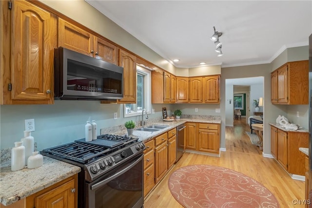 134 County Route 23a, Constantia, NY 13044 - kitchen with stainless steel appliances, brown cabinetry, ornamental molding, and light wood-style flooring