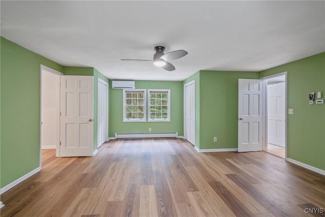 134 County Route 23a, Constantia, NY 13044 - unfurnished bedroom with a wall unit AC, a baseboard radiator, wood finished floors, and two closets
