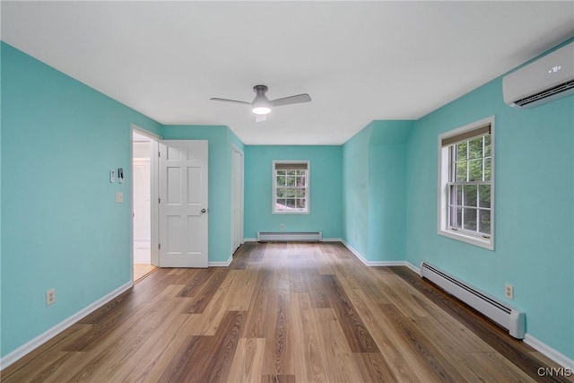 134 County Route 23a, Constantia, NY 13044 - unfurnished bedroom with a baseboard heating unit, a baseboard radiator, an AC wall unit, wood finished floors, and ceiling fan