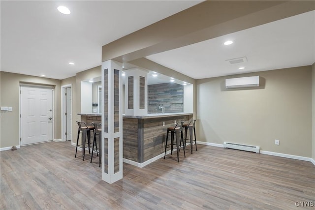 134 County Route 23a, Constantia, NY 13044 - indoor wet bar with a baseboard heating unit, an AC wall unit, wood finished floors, and recessed lighting