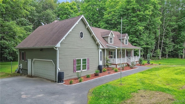 134 County Route 23a, Constantia, NY 13044 - cape cod house with a porch, a garage, a front yard, and a forest view