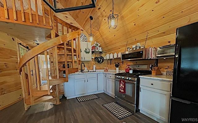 2473 Bunker Hill Rd, Cold Spring, NY 14772 - kitchen with appliances with stainless steel finishes, light countertops, dark wood-style floors, white cabinets, and wooden walls
