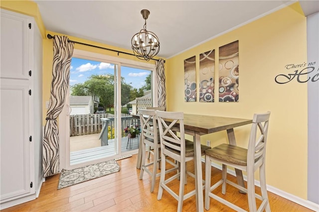 24 Huntsman, Webster, NY 14580 - dining area with light wood-style flooring and a chandelier