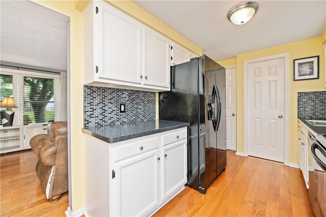 24 Huntsman, Webster, NY 14580 - kitchen with white cabinets, light wood-style flooring, dark countertops, and decorative backsplash