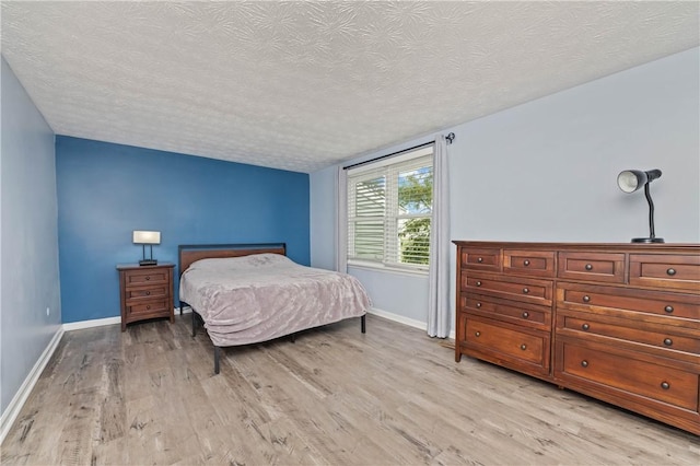 24 Huntsman, Webster, NY 14580 - bedroom featuring a textured ceiling and light wood-style floors