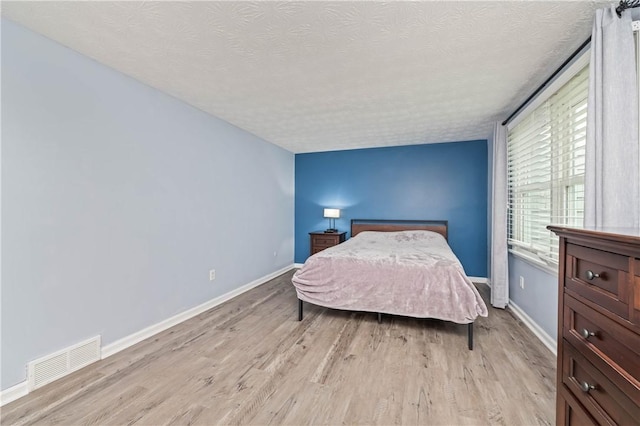 24 Huntsman, Webster, NY 14580 - bedroom with a textured ceiling and light wood finished floors