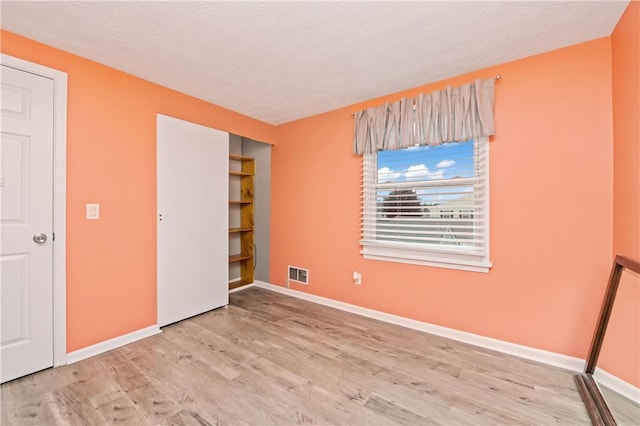 24 Huntsman, Webster, NY 14580 - unfurnished bedroom featuring wood finished floors and a textured ceiling