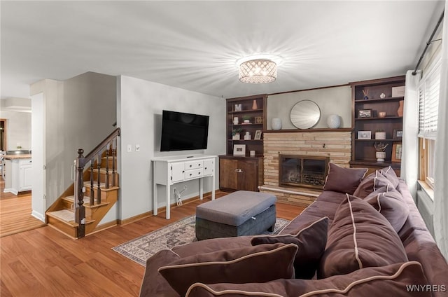 130 Hi View Ter, West Seneca, NY 14224 - living area with stairs, light wood-style floors, and a brick fireplace