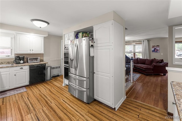 130 Hi View Ter, West Seneca, NY 14224 - kitchen featuring dishwasher, stainless steel fridge, light wood-style flooring, and white cabinetry