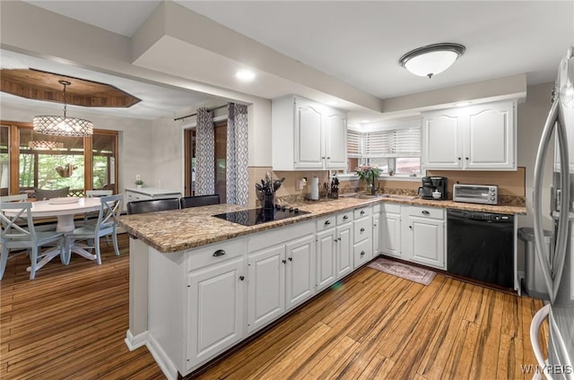 130 Hi View Ter, West Seneca, NY 14224 - kitchen with black appliances, white cabinets, light wood-style floors, and a peninsula