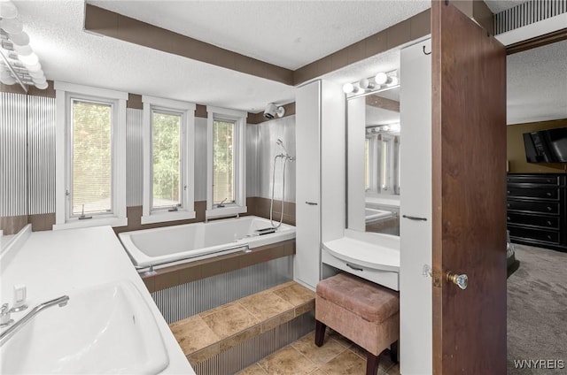 130 Hi View Ter, West Seneca, NY 14224 - bathroom with a textured ceiling, tiled tub, vanity, and tile patterned floors
