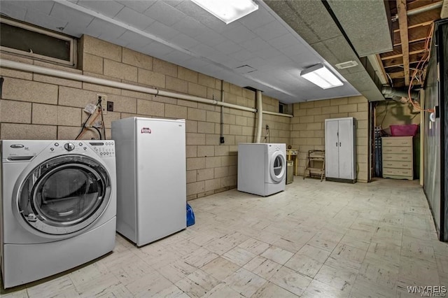 130 Hi View Ter, West Seneca, NY 14224 - washroom featuring washing machine and clothes dryer, concrete block wall, and light flooring