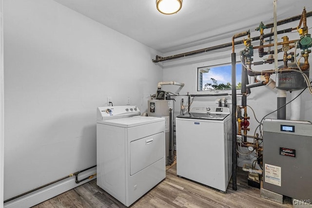 8953 Bushnell Shore Rd, Sullivan, NY 13037 - washroom featuring washer and clothes dryer, water heater, and light wood-style flooring