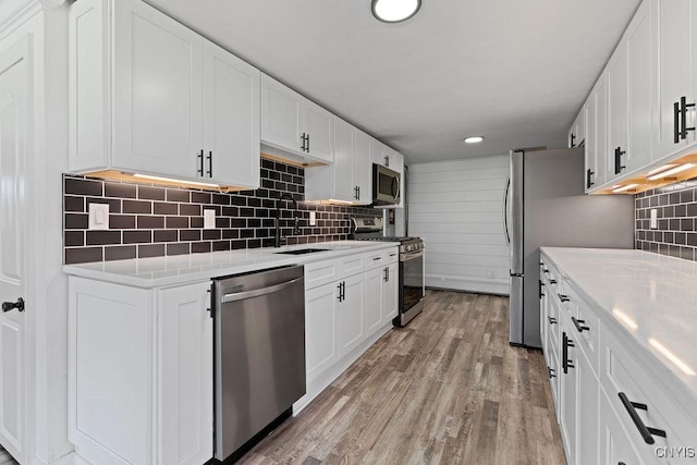 8953 Bushnell Shore Rd, Sullivan, NY 13037 - kitchen with appliances with stainless steel finishes, light countertops, white cabinetry, backsplash, and recessed lighting