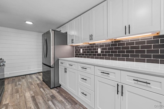 8953 Bushnell Shore Rd, Sullivan, NY 13037 - kitchen with appliances with stainless steel finishes, white cabinets, dark wood-style flooring, recessed lighting, and tasteful backsplash