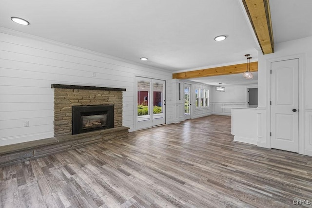 8953 Bushnell Shore Rd, Sullivan, NY 13037 - unfurnished living room featuring beam ceiling, wood finished floors, a stone fireplace, recessed lighting, and ornamental molding