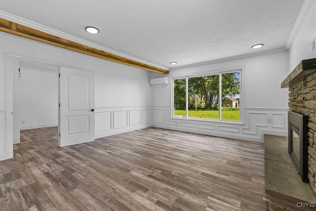 8953 Bushnell Shore Rd, Sullivan, NY 13037 - unfurnished living room with a wall unit AC, a fireplace, ornamental molding, wood finished floors, and a wainscoted wall