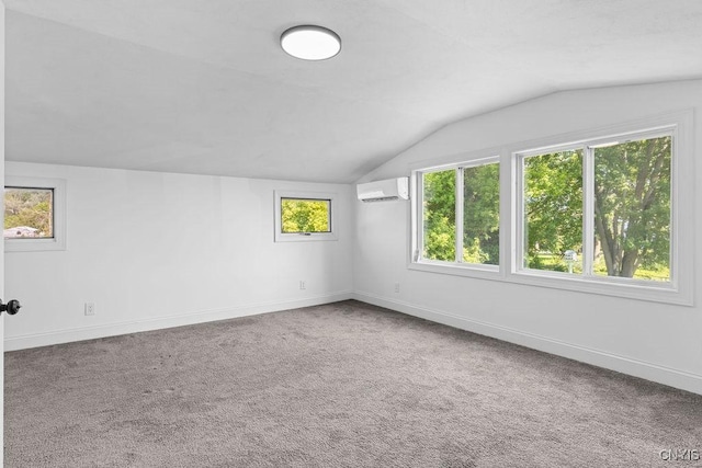 8953 Bushnell Shore Rd, Sullivan, NY 13037 - spare room featuring a wall mounted air conditioner, vaulted ceiling, and carpet flooring