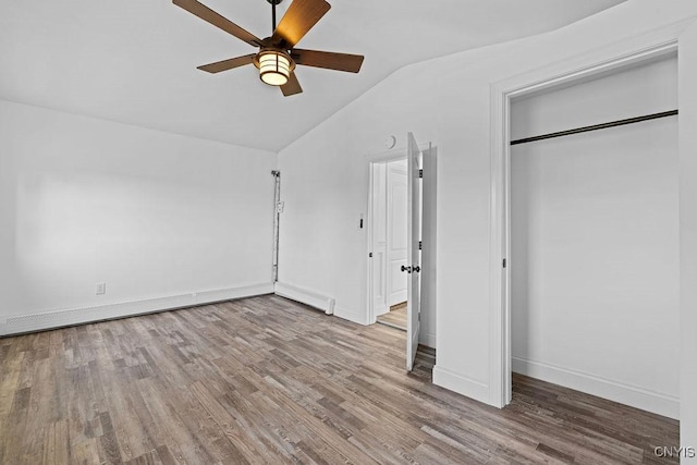 8953 Bushnell Shore Rd, Sullivan, NY 13037 - unfurnished bedroom featuring vaulted ceiling, wood finished floors, a ceiling fan, and a closet