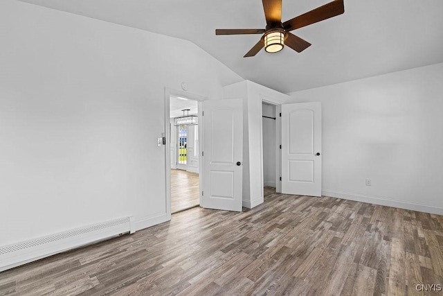 8953 Bushnell Shore Rd, Sullivan, NY 13037 - unfurnished bedroom featuring wood finished floors, lofted ceiling, baseboard heating, and a ceiling fan