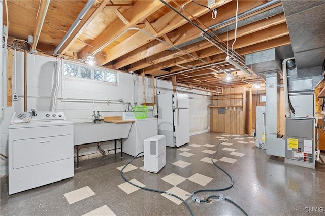 178 Wainwright Ave, Syracuse, NY 13208 - below grade area with washer and clothes dryer, freestanding refrigerator, tile patterned floors, heating unit, and gas water heater