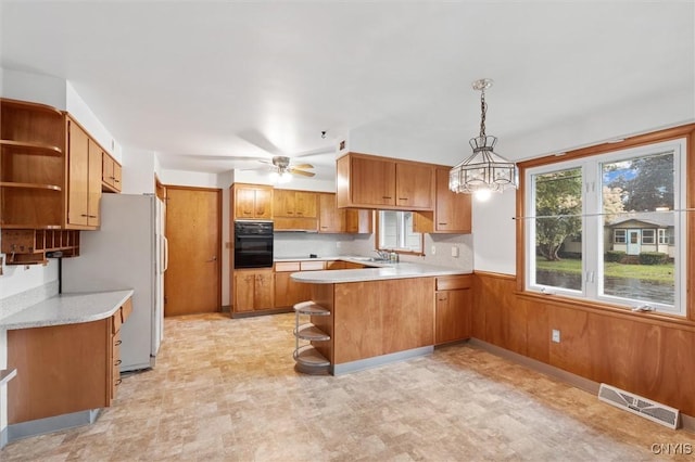 178 Wainwright Ave, Syracuse, NY 13208 - kitchen with open shelves, oven, a peninsula, brown cabinetry, and light countertops