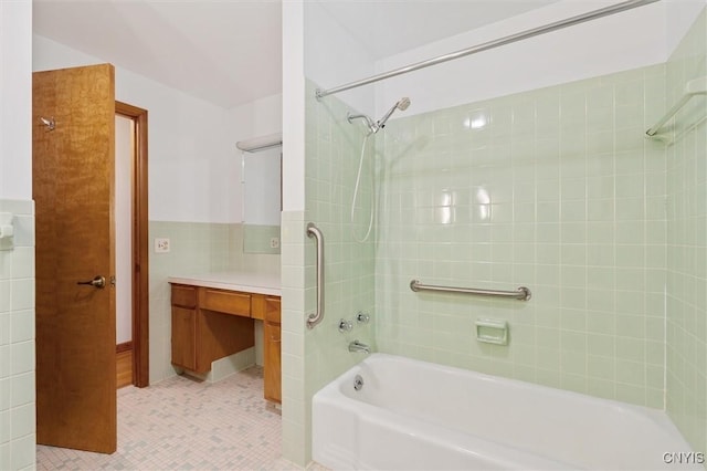 178 Wainwright Ave, Syracuse, NY 13208 - bathroom featuring tile walls, bathtub / shower combination, vanity, tile patterned floors, and wainscoting
