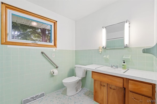 178 Wainwright Ave, Syracuse, NY 13208 - bathroom featuring tile walls, vanity, tile patterned flooring, and a wainscoted wall