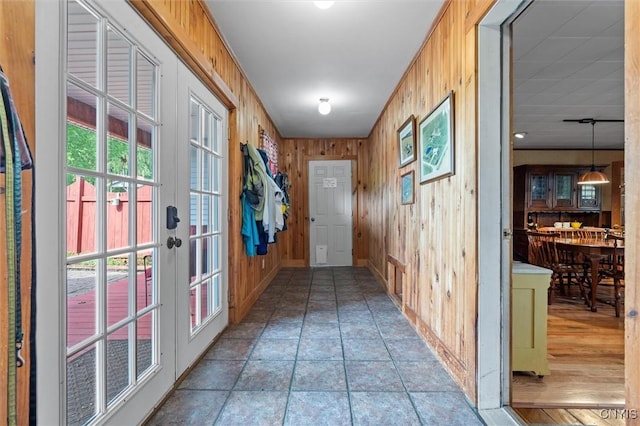 6767 Stauber Rd, Summerhill, NY 13073 - doorway to outside featuring stone finish floors and wooden walls