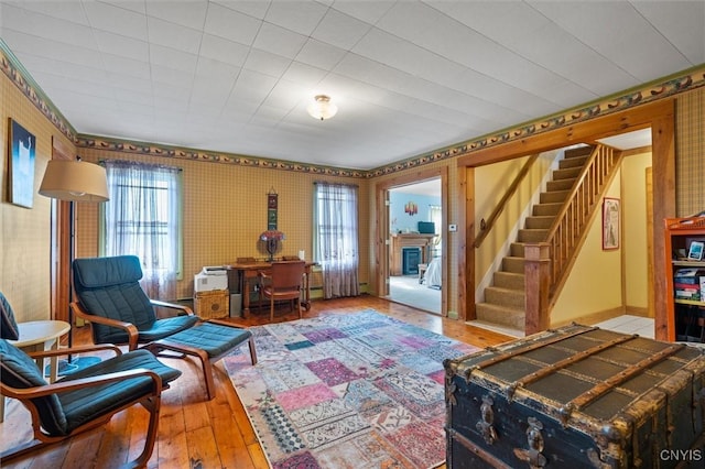 6767 Stauber Rd, Summerhill, NY 13073 - living area featuring stairs, plenty of natural light, hardwood / wood-style floors, and wallpapered walls