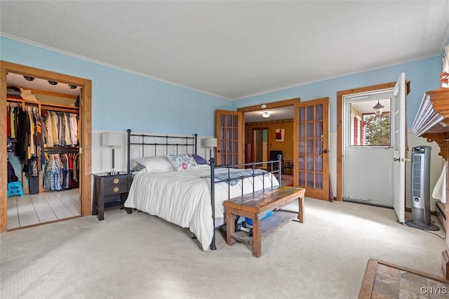 6767 Stauber Rd, Summerhill, NY 13073 - bedroom with french doors, carpet, crown molding, and a spacious closet