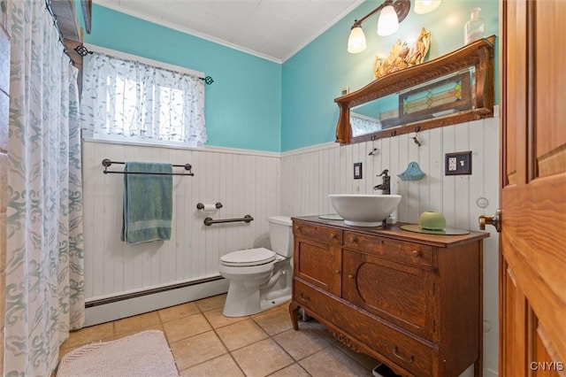 6767 Stauber Rd, Summerhill, NY 13073 - bathroom featuring a baseboard heating unit, ornamental molding, vanity, wainscoting, and tile patterned floors