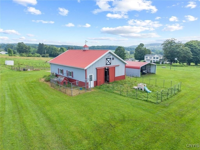 6767 Stauber Rd, Summerhill, NY 13073 - view of home's exterior featuring an outbuilding, a metal roof, board and batten siding, and a view of rural / pastoral area