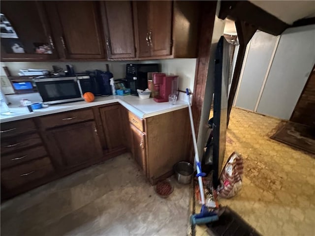 135 William St, Palmyra, NY 14522 - kitchen featuring stainless steel microwave, light countertops, and built in desk