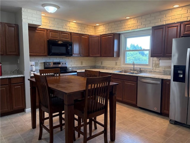 1292 Gassner Rd, Junius, NY 13165 - kitchen with appliances with stainless steel finishes, tasteful backsplash, light tile patterned floors, and light stone countertops