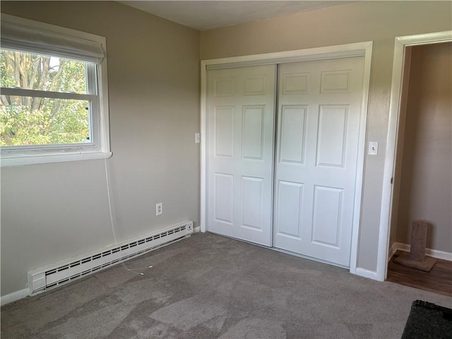 1292 Gassner Rd, Junius, NY 13165 - unfurnished bedroom with a baseboard radiator, carpet, and a closet