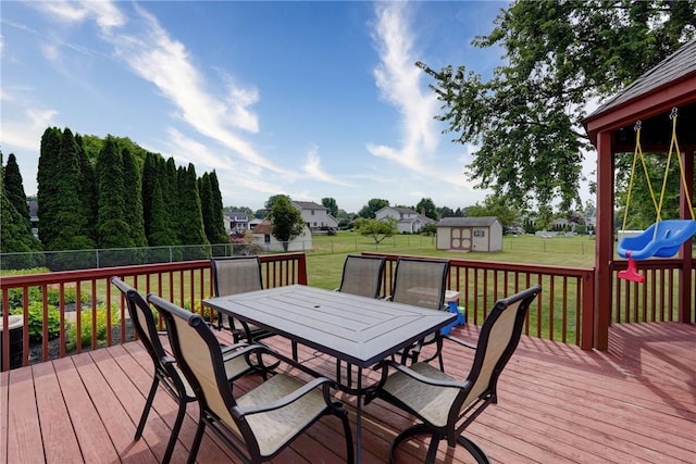 1125 Shoecraft Rd, Webster, NY 14580 - wooden deck with outdoor dining area, a storage shed, and a fenced backyard