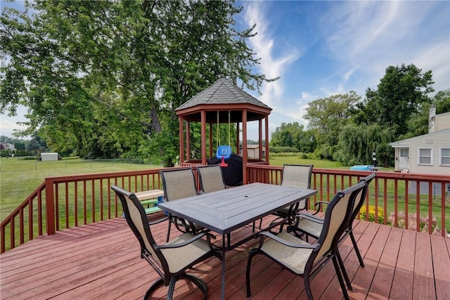 1125 Shoecraft Rd, Webster, NY 14580 - wooden terrace with a gazebo, outdoor dining space, a lawn, and view of wooded area