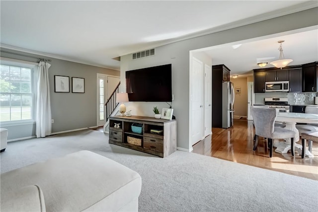 1125 Shoecraft Rd, Webster, NY 14580 - living area featuring light colored carpet, plenty of natural light, and stairs
