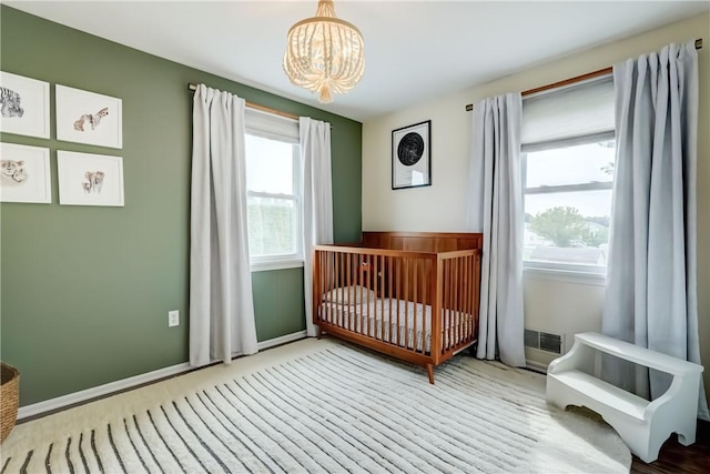1125 Shoecraft Rd, Webster, NY 14580 - bedroom featuring a chandelier and a nursery area