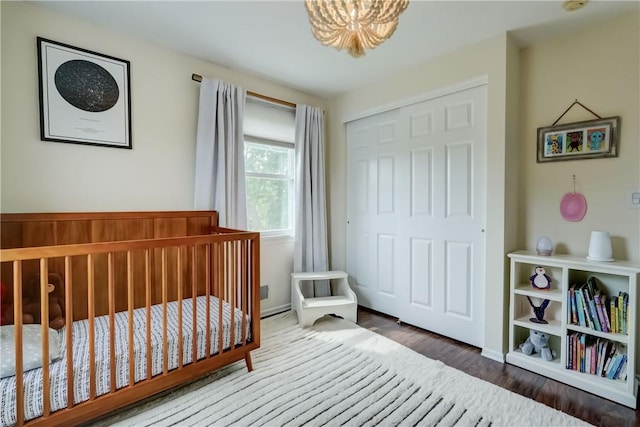 1125 Shoecraft Rd, Webster, NY 14580 - bedroom featuring a chandelier, wood finished floors, and a closet