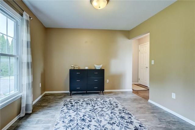 1125 Shoecraft Rd, Webster, NY 14580 - bedroom featuring multiple windows and wood finished floors