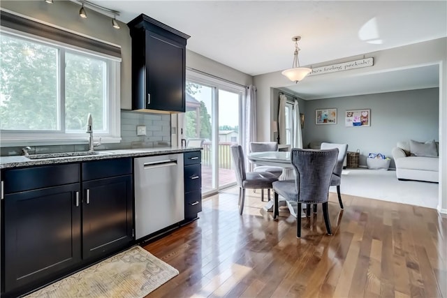 1125 Shoecraft Rd, Webster, NY 14580 - kitchen featuring stainless steel dishwasher, dark wood-style floors, light stone countertops, open floor plan, and tasteful backsplash