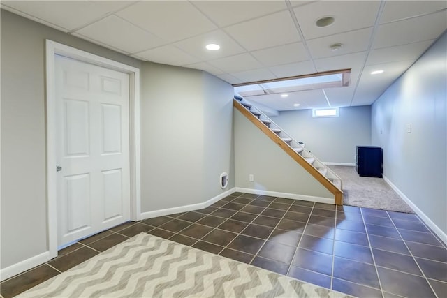 1125 Shoecraft Rd, Webster, NY 14580 - basement featuring dark tile patterned floors, stairs, and a drop ceiling